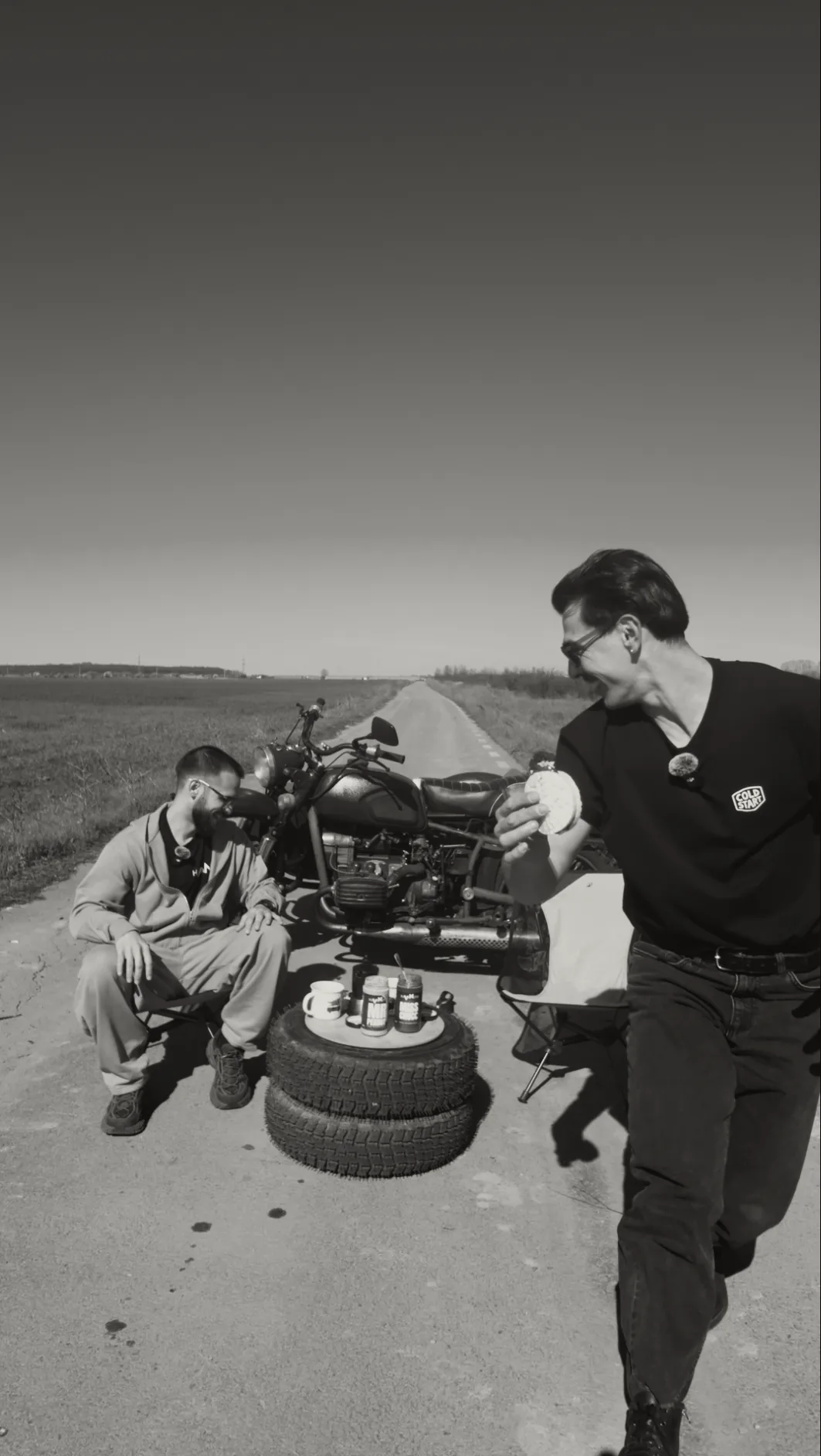 Cold Start crew taking a roadside coffee break next to a motorcycle